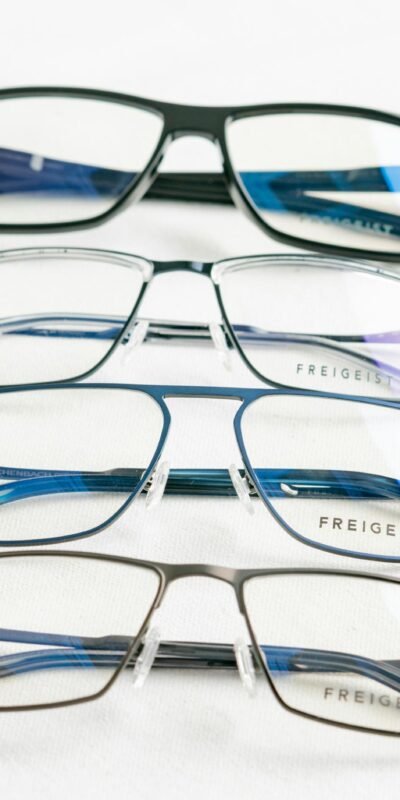 A close-up of modern Freigeist eyeglasses on a white surface.