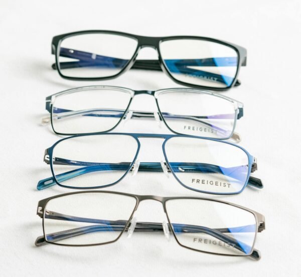 A close-up of modern Freigeist eyeglasses on a white surface.