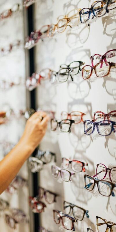 A vibrant selection of eyeglasses in various styles on display at an optical store.
