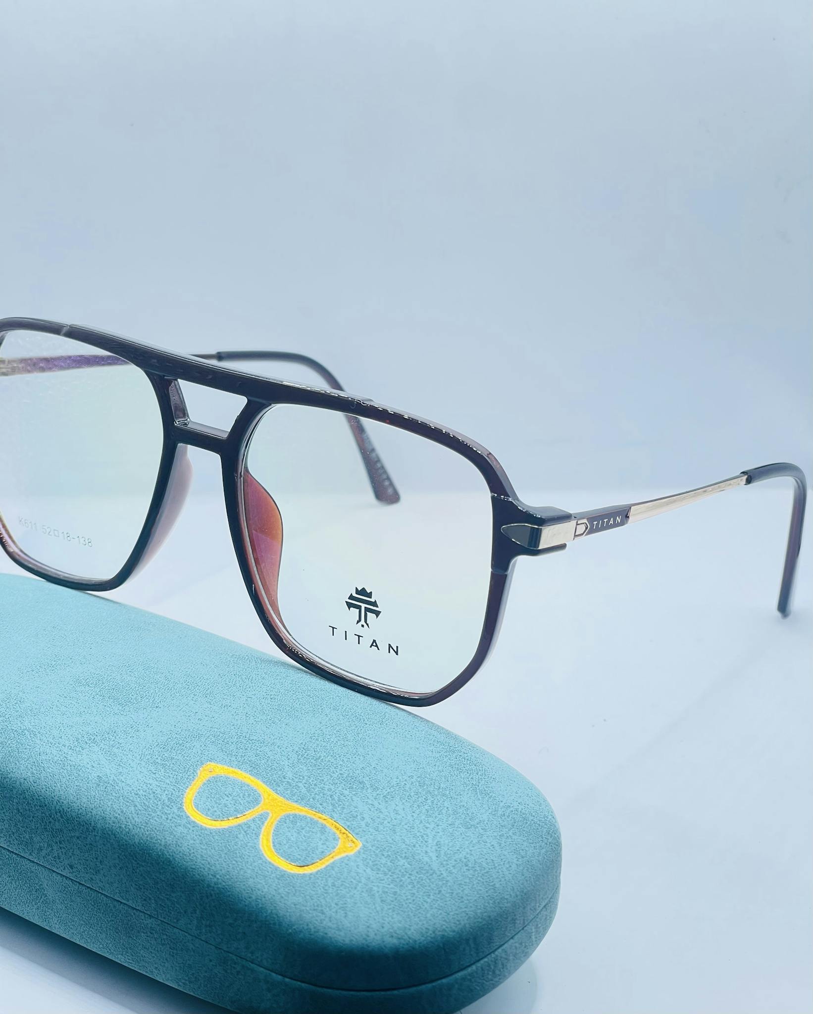 Close-up of fashionable eyeglasses with a blue protective case, ideal for modern style.